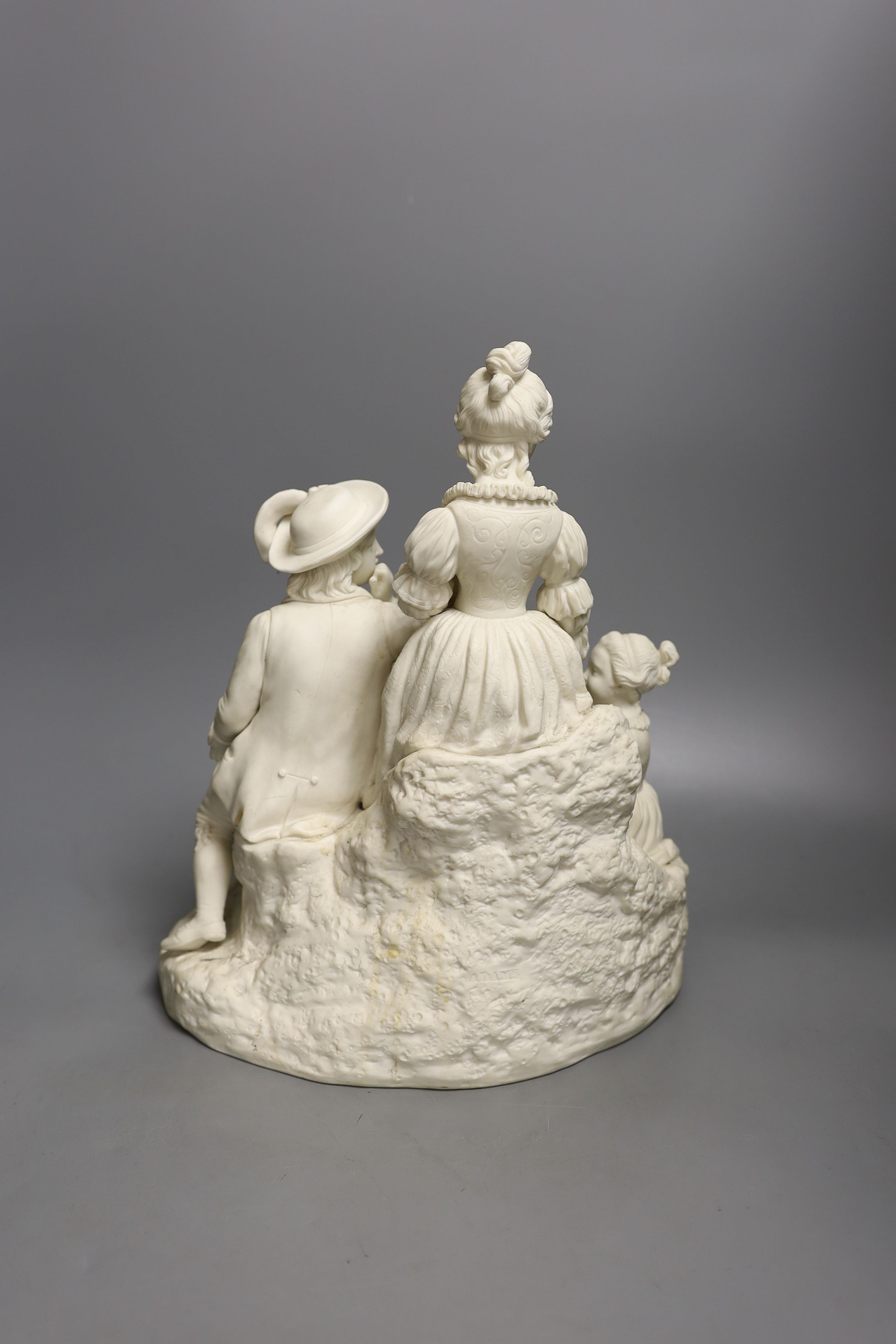A 19th century Adams & Co. parian group of a man, woman, child and dog 31cm